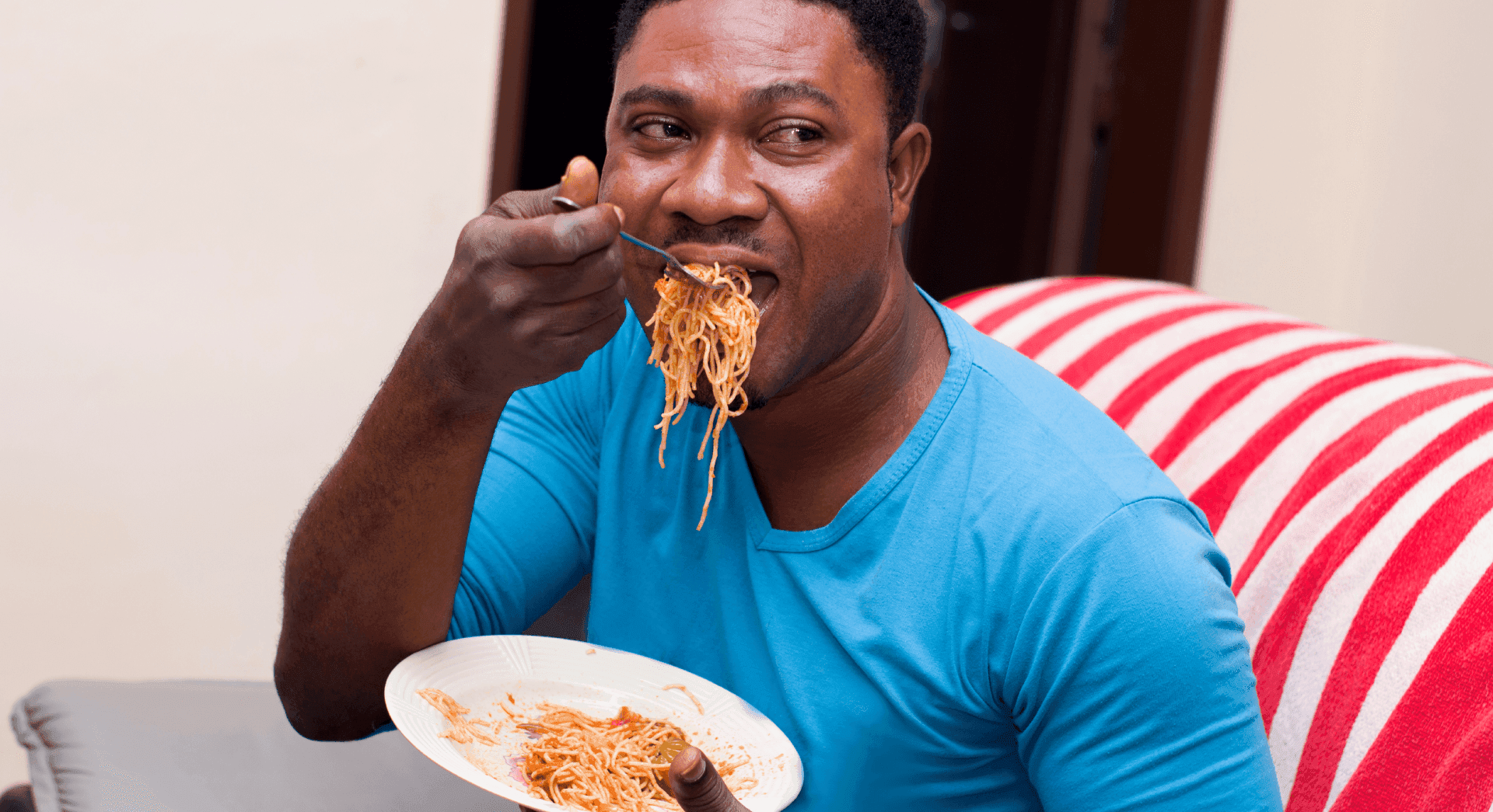 Man enjoying a bowl of Indomie noodles